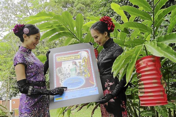 Classic event: Two cheongsam clad models posing for a photo session after Penang Municipal Council president Datuk Patahiyah Ismail held a press conference to announce the second Mid-Autumn FestoRama@The Pearl of the Orient 2013 event at the Information Centre in Penang Municipal Park.